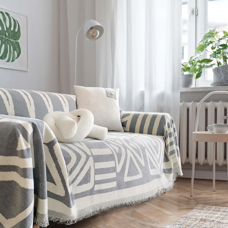 Spark Paws pet couch cover in grey on a sectional