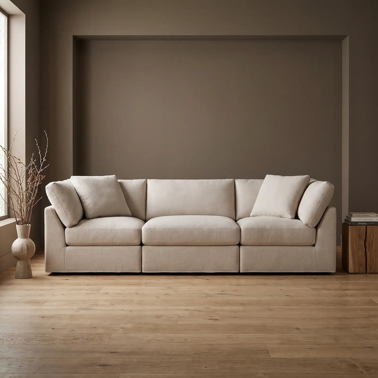 The Sundays Get Together 3-Piece Modular Sofa in Clay, styled against a deep taupe wall in a bright, minimally furnished living room