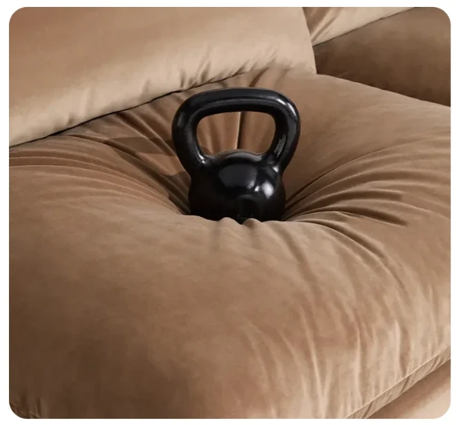 A black kettlebell sinking into a tan Cush seat cushion filled with Ultraloft Fill