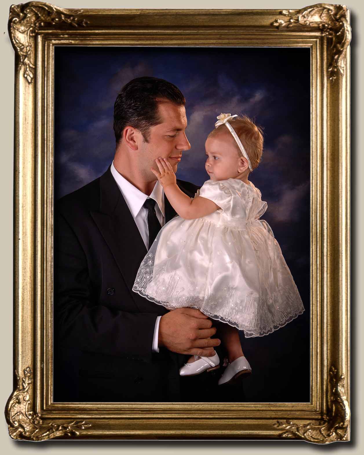 A fine art portrait of a father and his baby girl