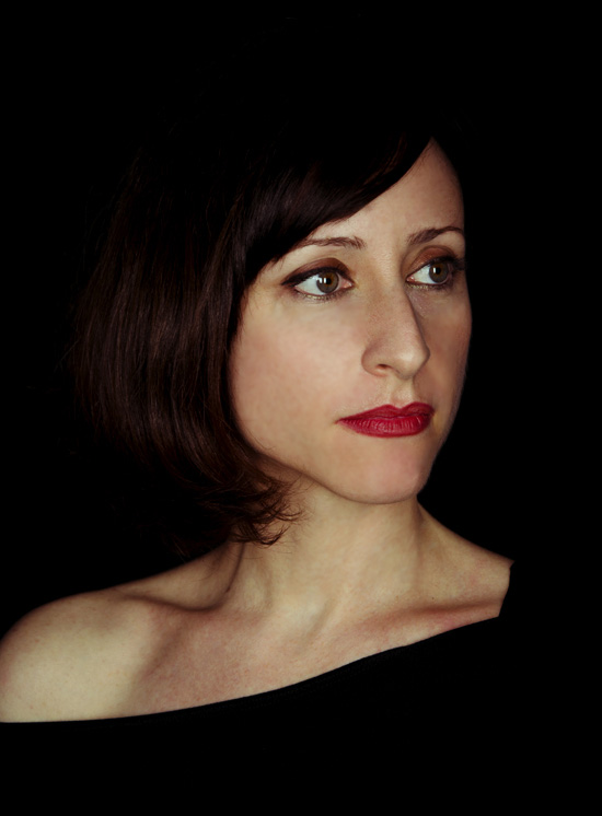 Portrait of Lidia Vinyes Curtis with black background behind