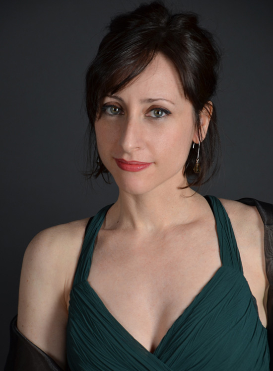 Portrait of Lidia Vinyes Curtis with green dress and grey background