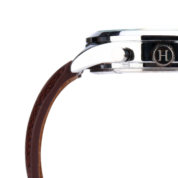 Detailed shot of the polished HMS watch case, crown, and integrated leather strap, highlighting the precision engineering and excellence in every material