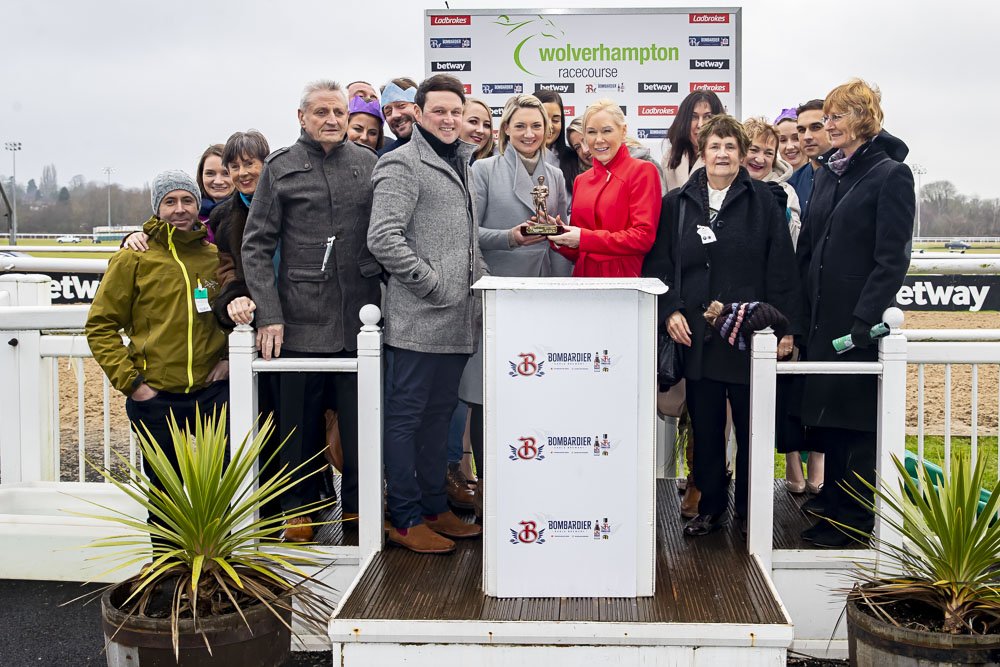 Owners celebrating with the trophy in the winners' enclosure at Wolverhampton Racecourse