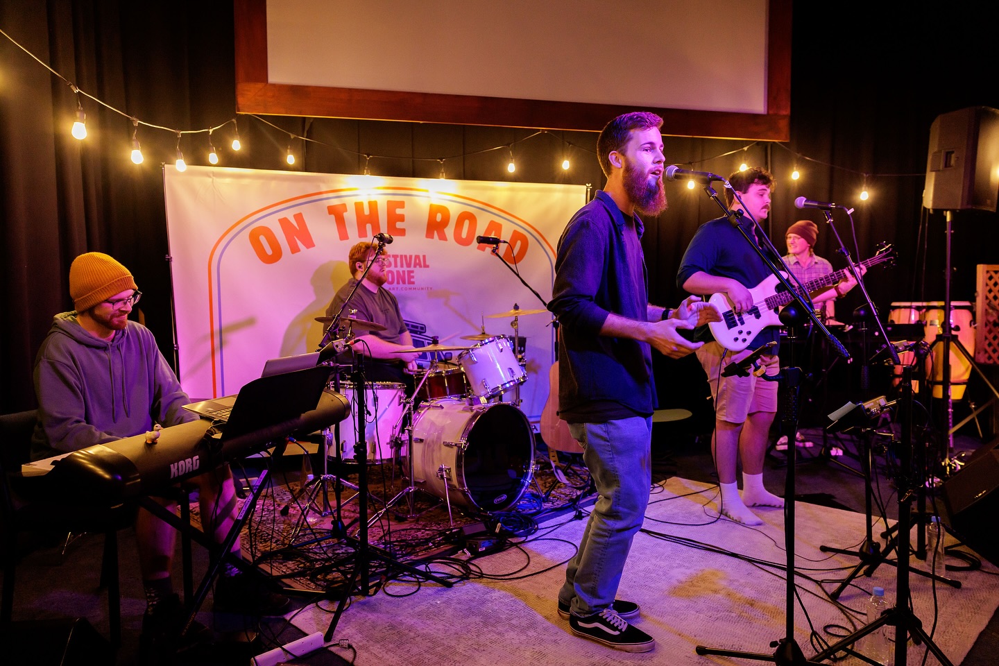May be an image of 5 people, guitar, piano, saxophone and text that says "ON THE ONE STIVAL ONTHEROA OESTIVAL ROAD R04"