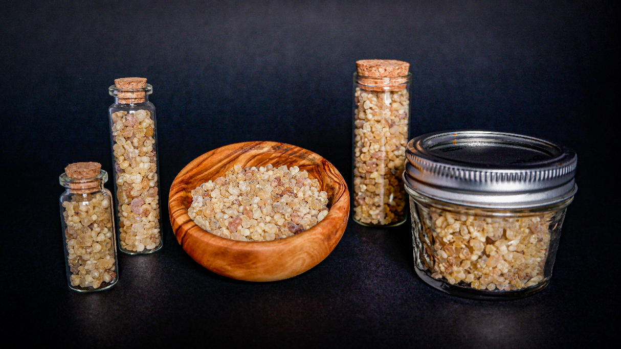 Frankincense in glass jars and wooden bowl. 
