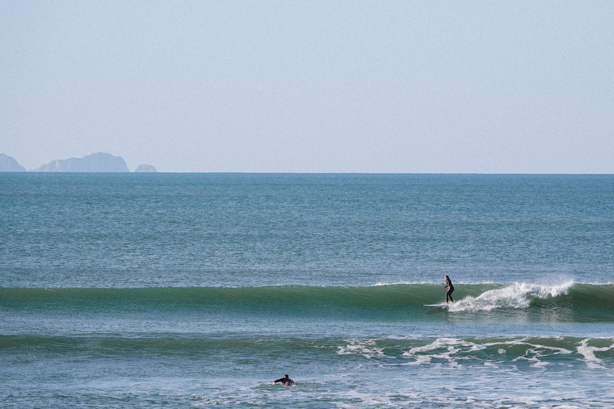 A surfer riding a mellow righthander wave in Baleal, Peniche