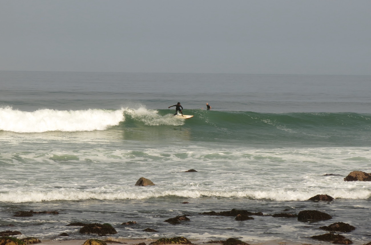 local surfer riding a long wave in angola