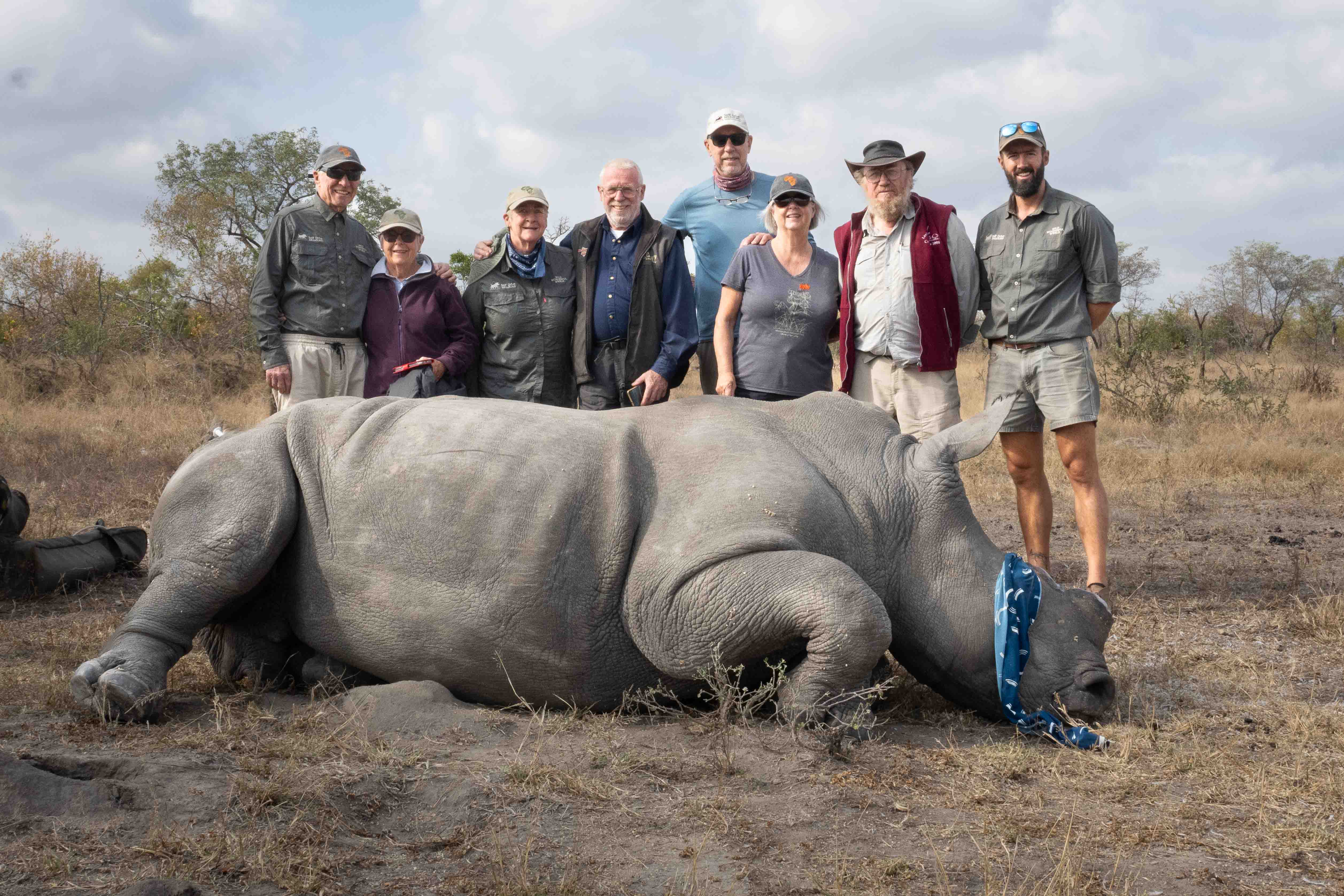 Travelers with a rhino that had its horn trimmed for conservation. Wild Wonderful World Safaris