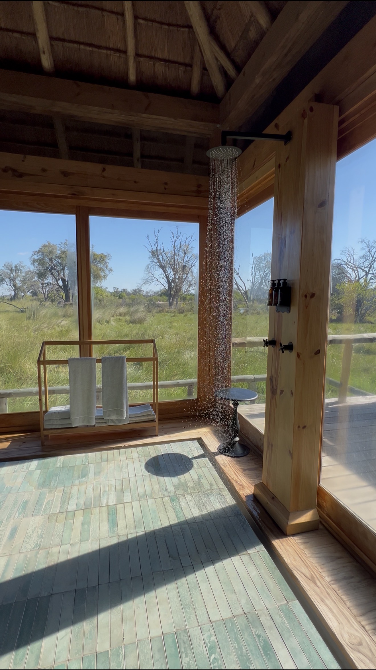 A rainshower overlooking the permanent floodwaters of the Delta, immersive and utterly luxurious. Taken at Wilderness Vumbura Plains.