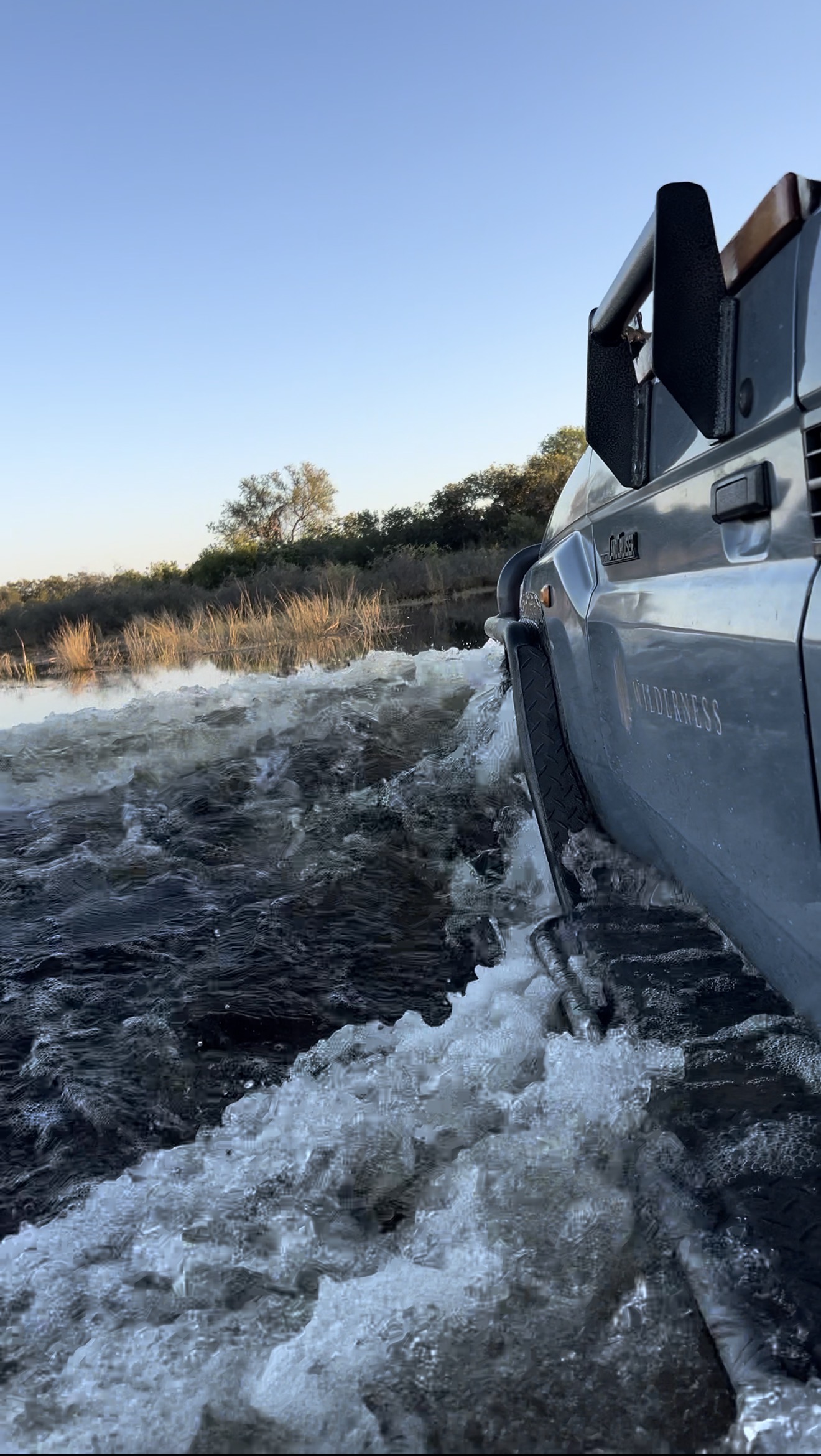 a gameviewer driving through the Delta flood waters
