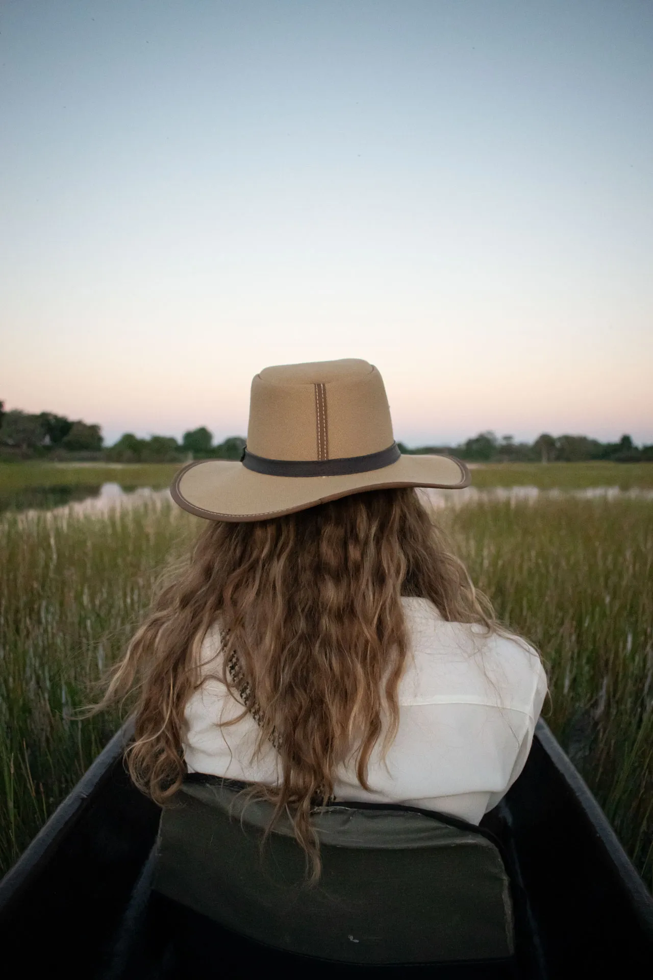 a photo of a woman sitting in a mokoro