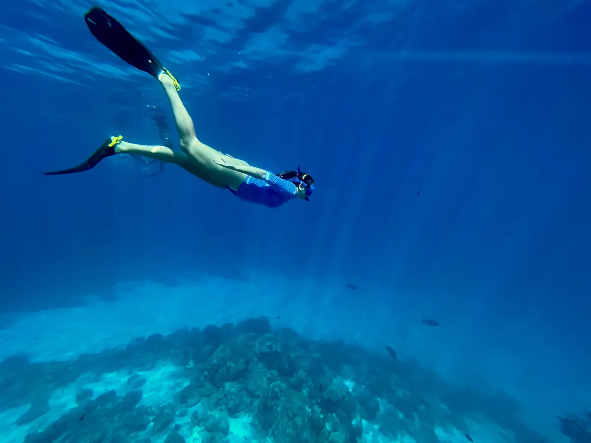 woman snorkeling in blue water