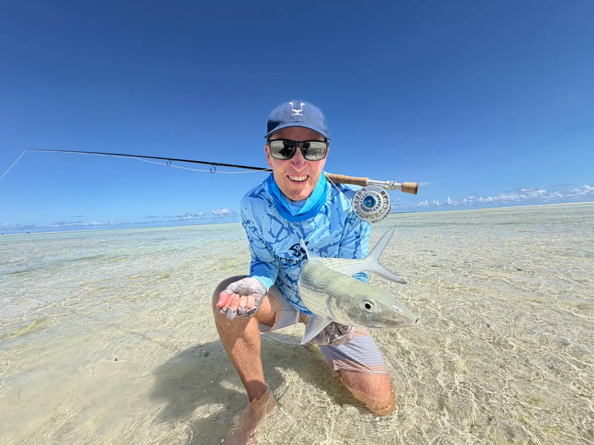 Man holding fish in the ocean