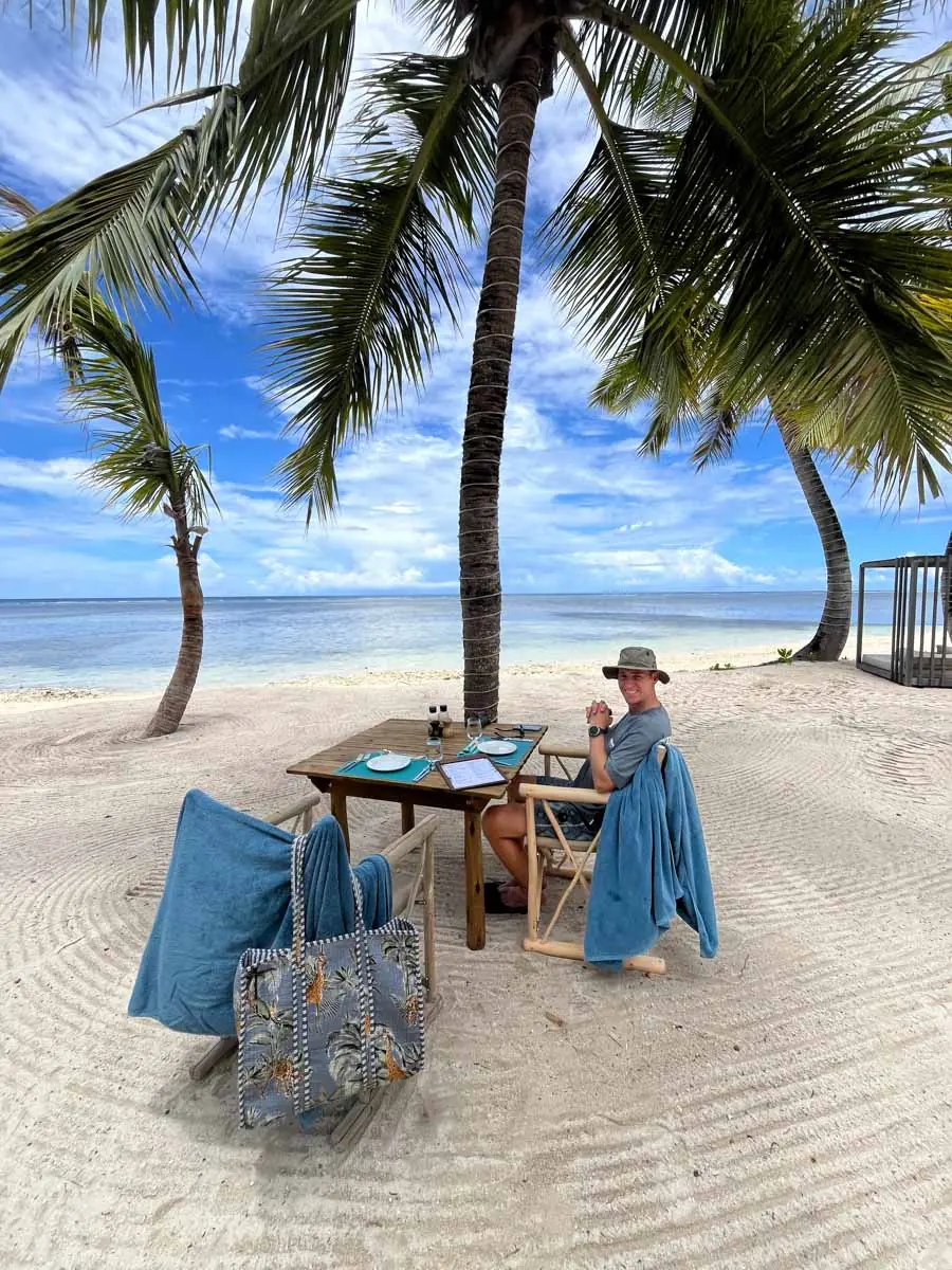 Man sitting at table on tropical beach