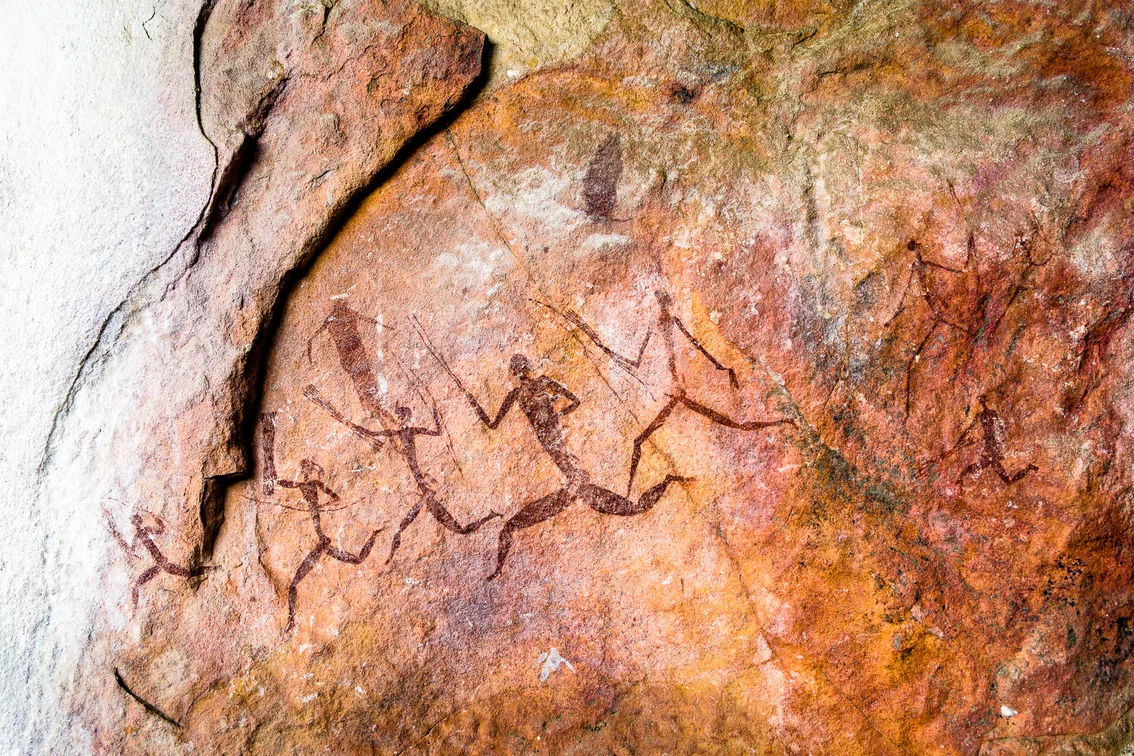 Ancient rock paintings of running human figures in red pigment at Singita Pamushana’s Malilangwe Reserve, Zimbabwe