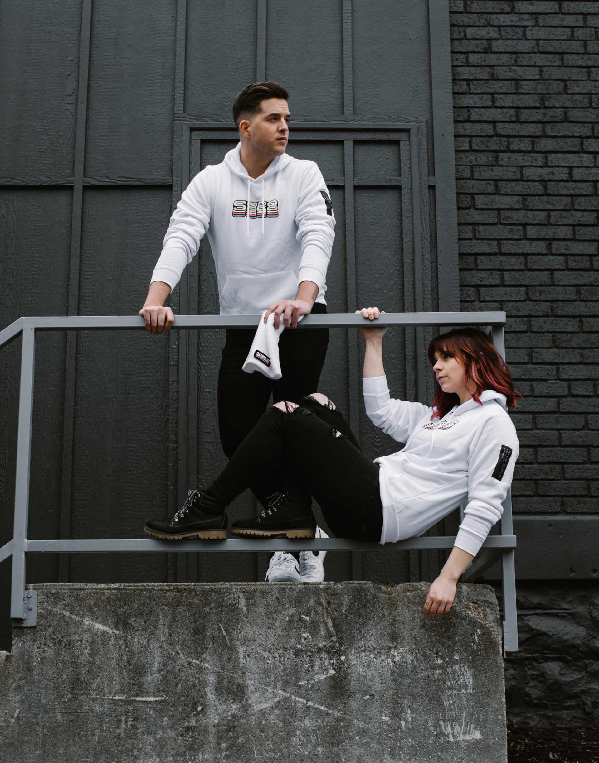 Photo of two Studio 8E8 dental marketing team members wearing their white S8E8 hoodies.