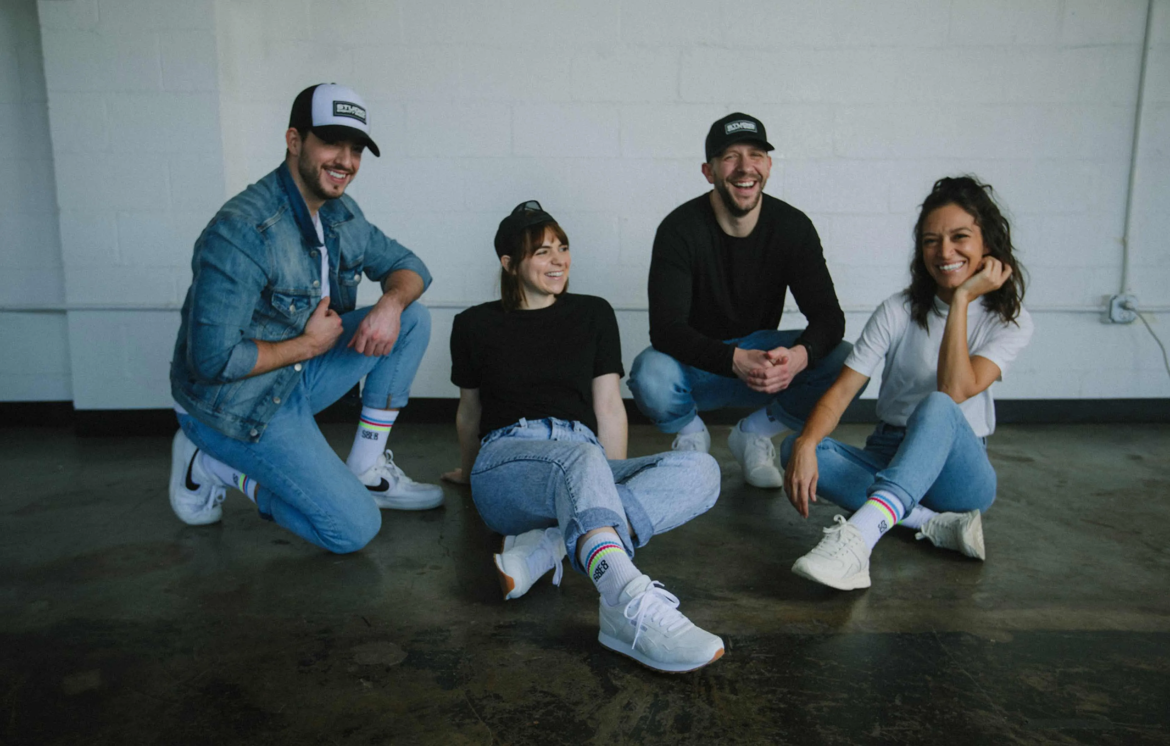 Photo of the Studio 8E8 team wearing their hats and socks