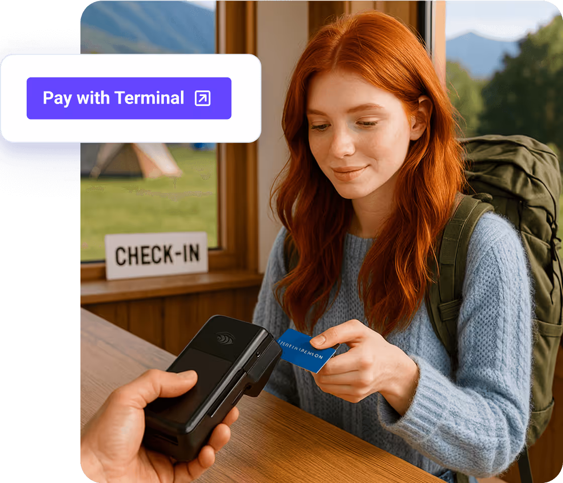 Guest tapping a card on a handheld terminal at check-in.