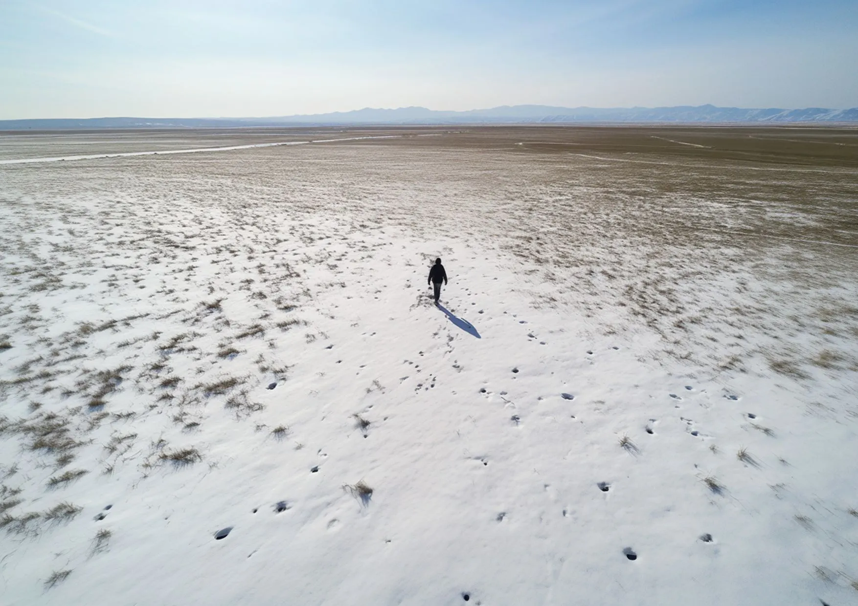 AI image, a solo man walking in a frozen landscape