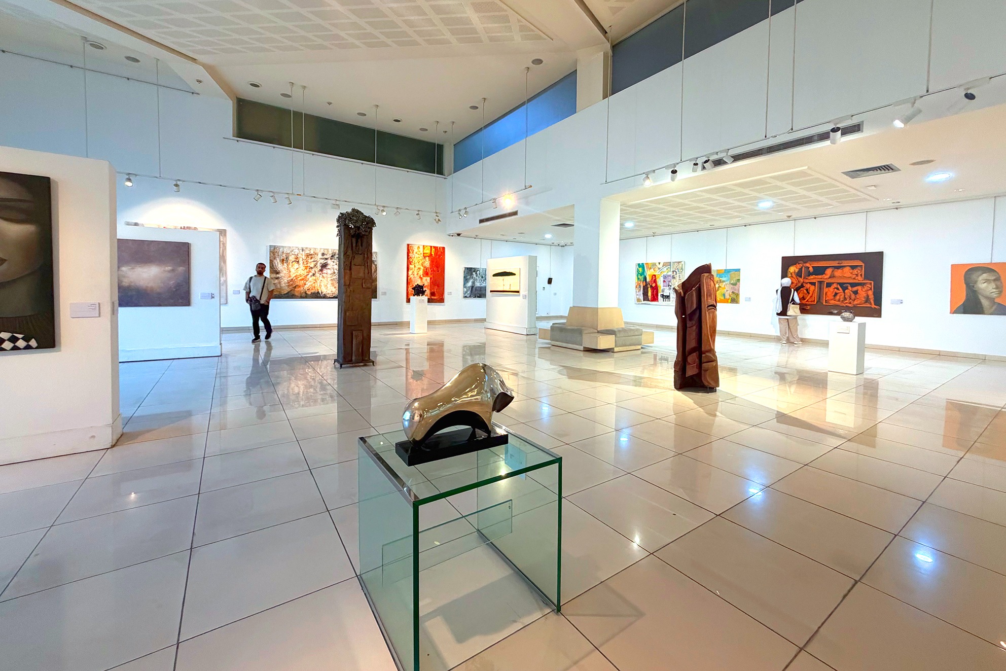 Gallery view with sculptures on plinths and paintings on white display walls at Art Leaves Its Mark, 2026. Photograph by Khaled Barakeh.