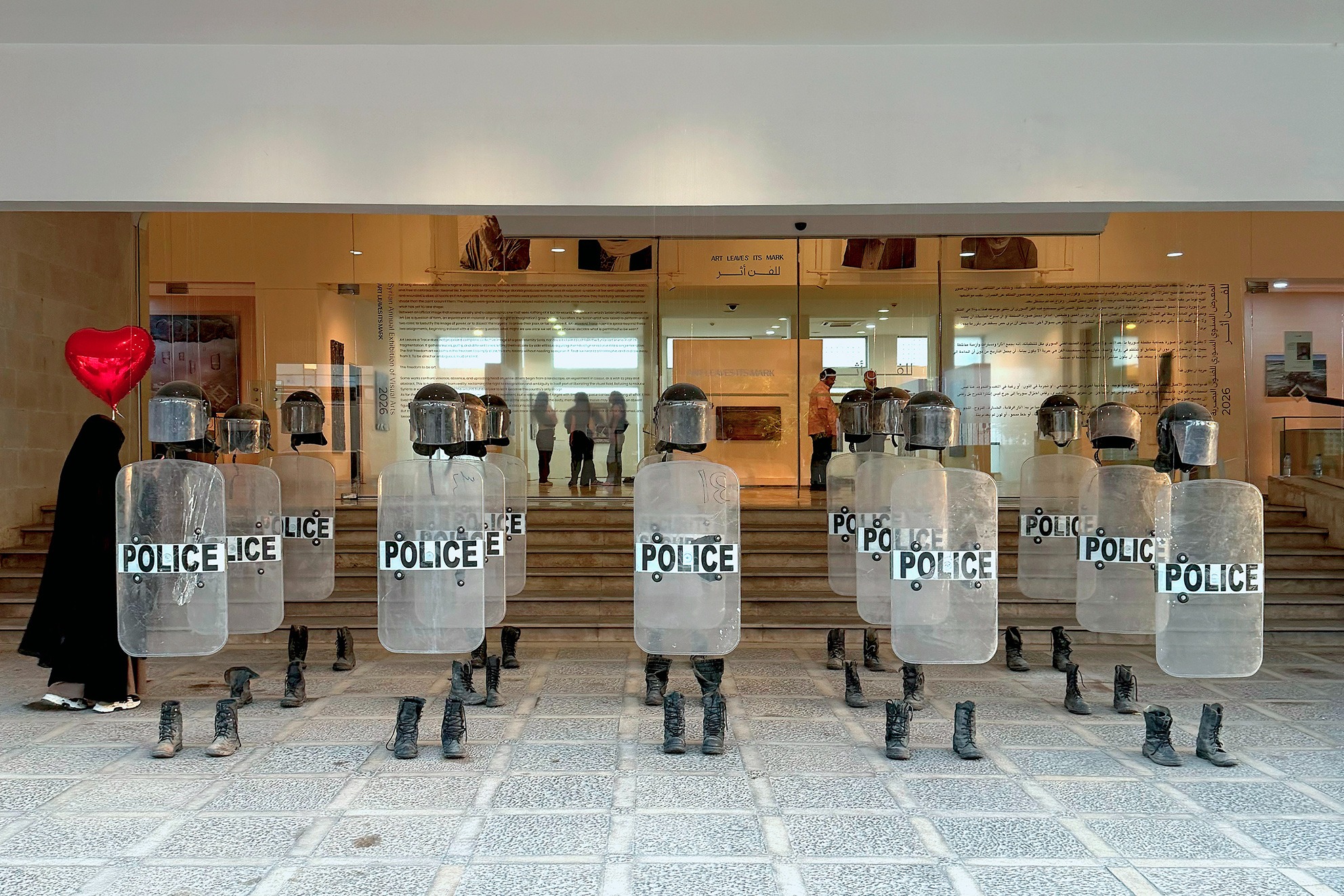 Anatomy of Fragility figures with police shields installed at the exhibition entrance. Photograph by Khaled Barakeh.