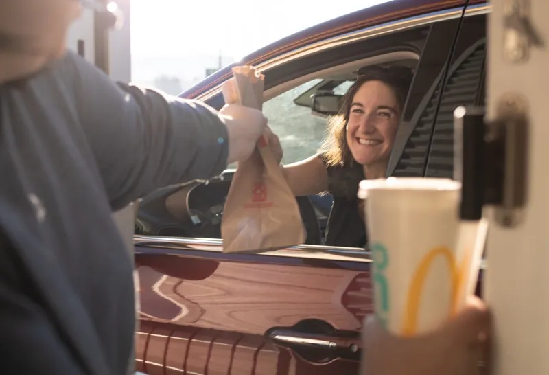 woman receiving food in drive thru
