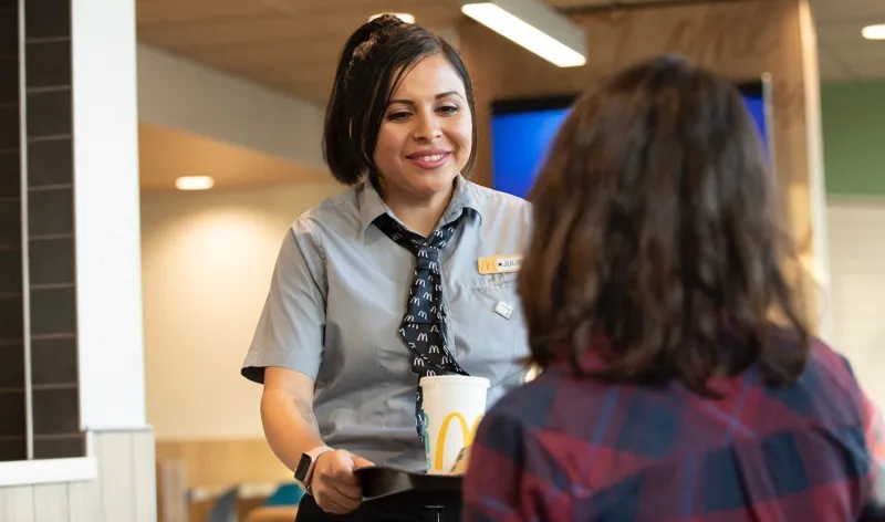 woman serving food to customer