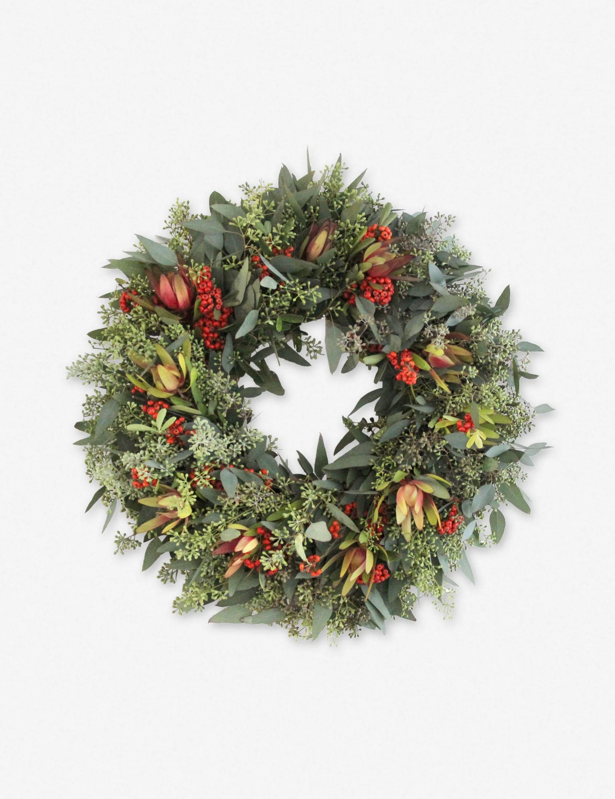 Decorative wreath made of green leaves, small red berries, and yellowish-red flower buds on a white background.