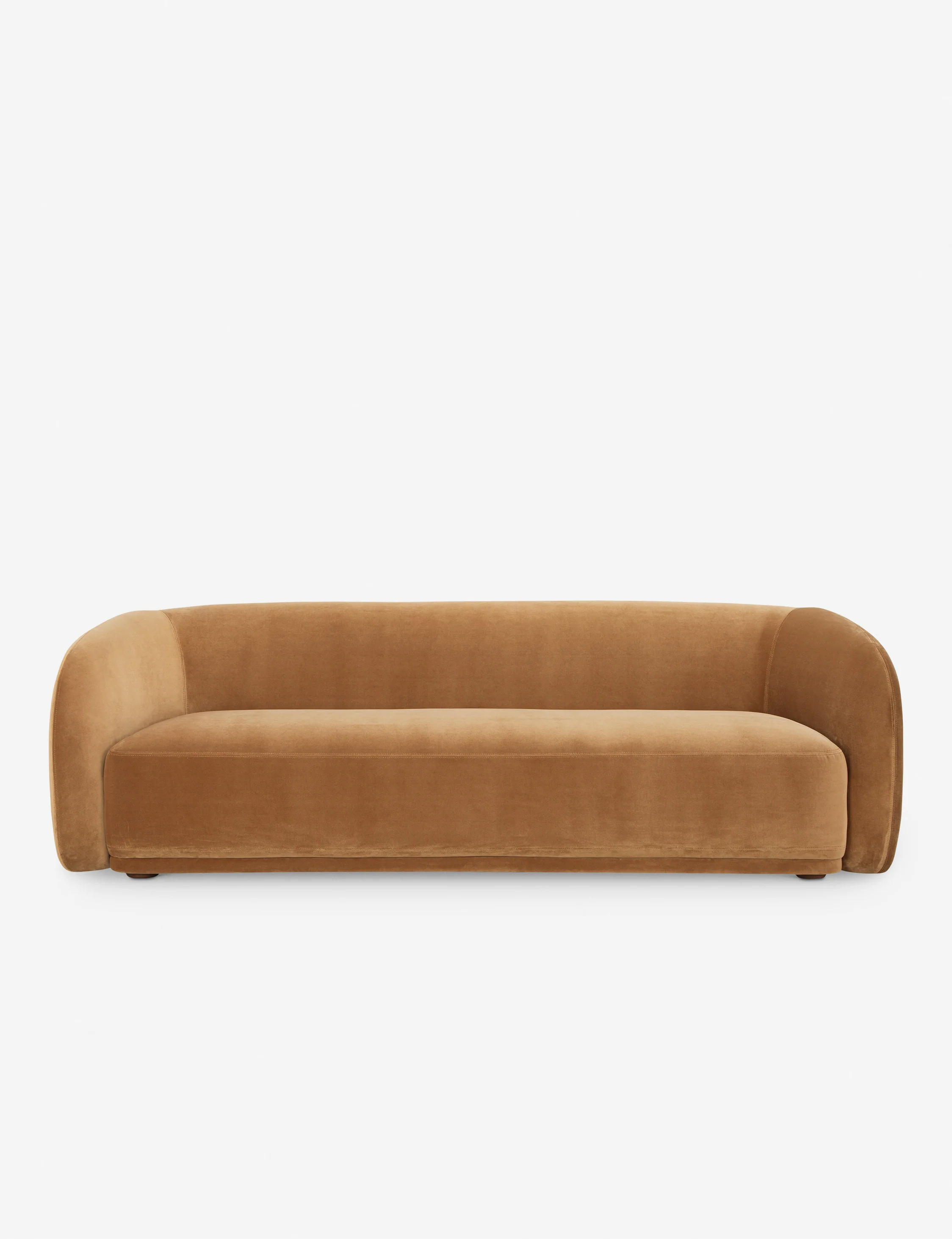 Modern caramel brown velvet sofa with rounded arms and no visible legs on a white background.