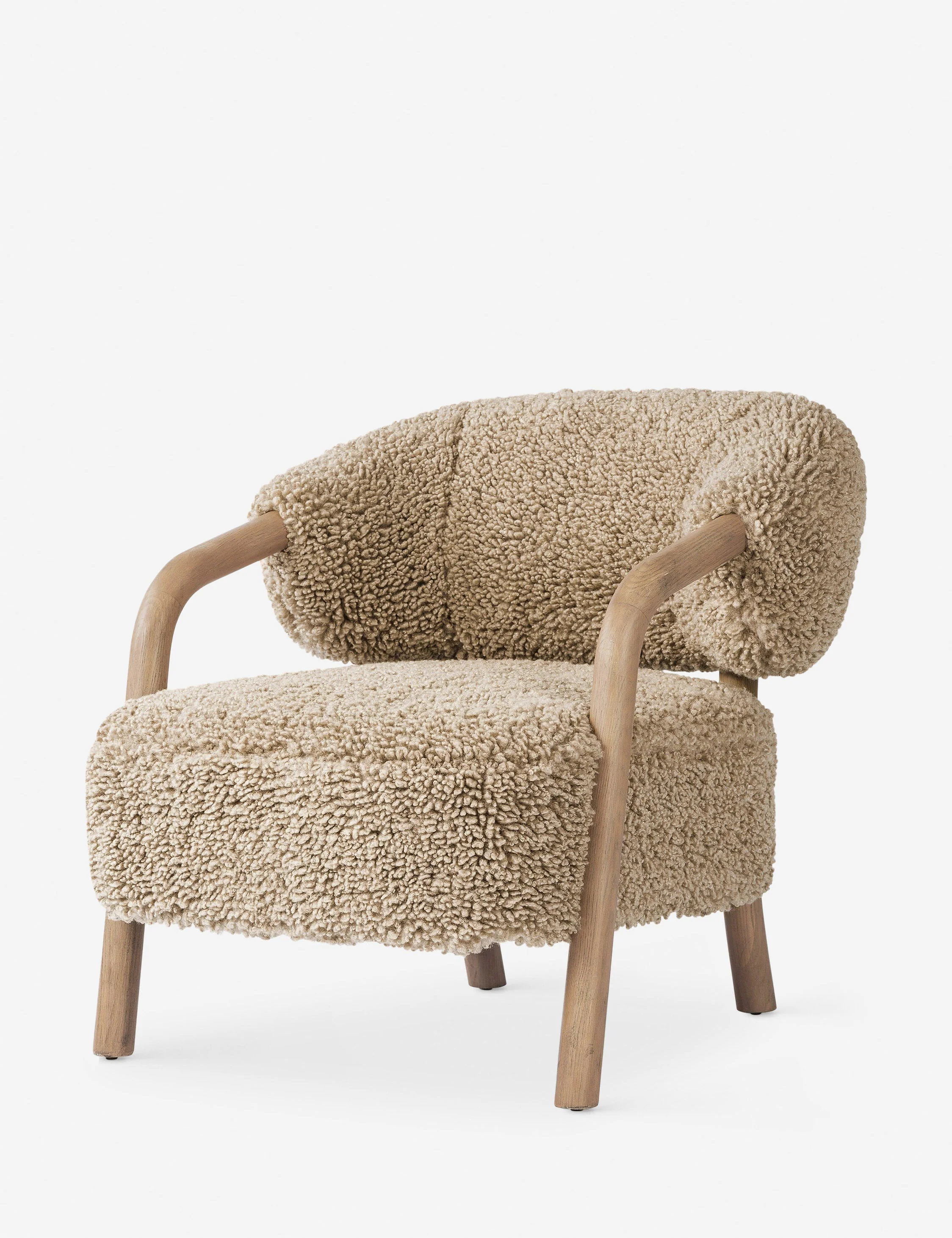 Beige sherpa upholstered accent chair with curved wooden armrests and legs.