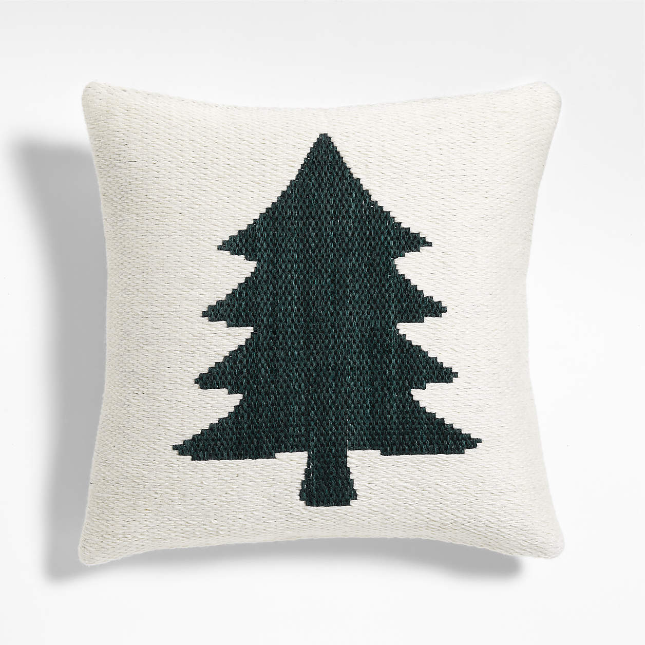 Square white woven pillow with a large dark green tree silhouette in the center.
