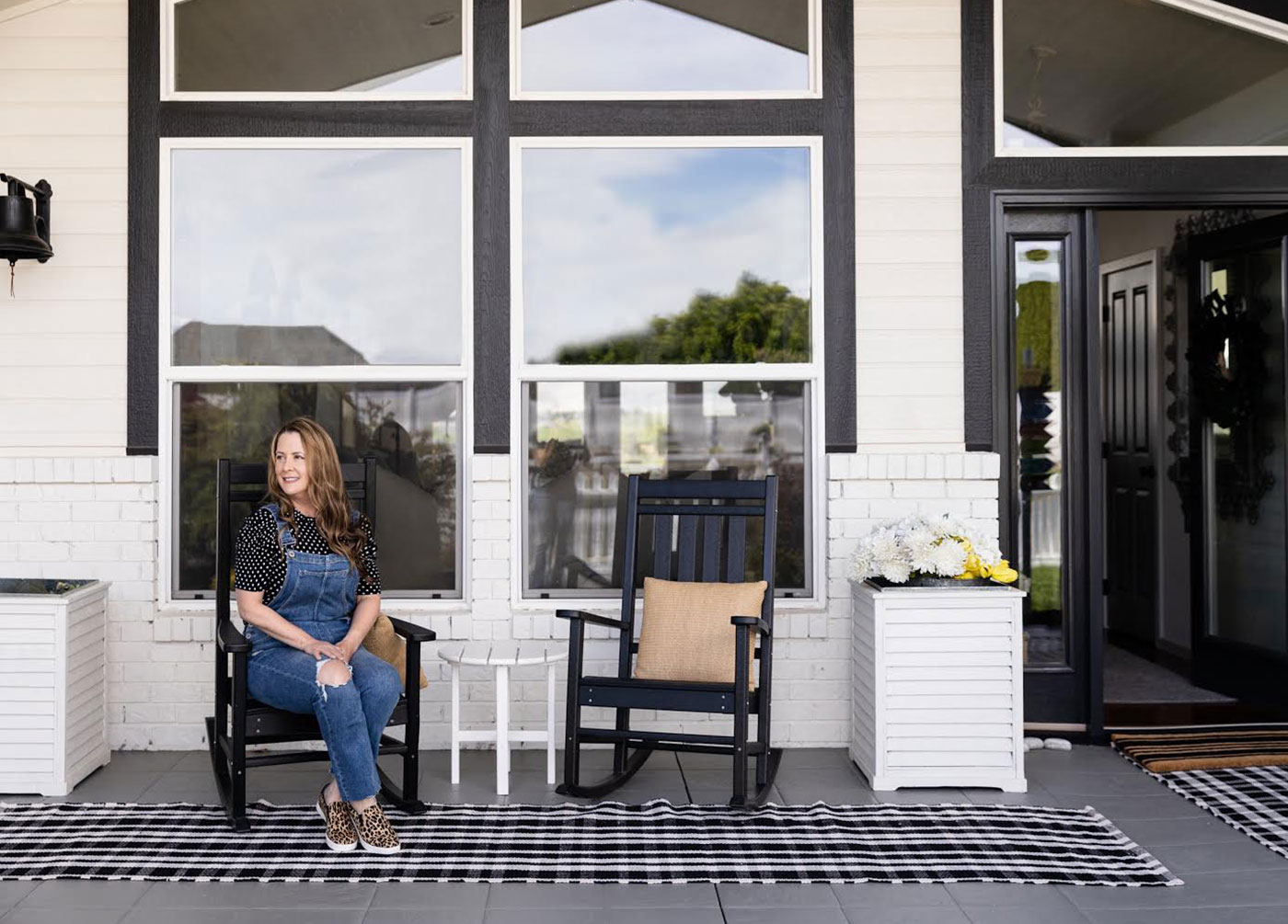 Woman sitting on front porch furniture