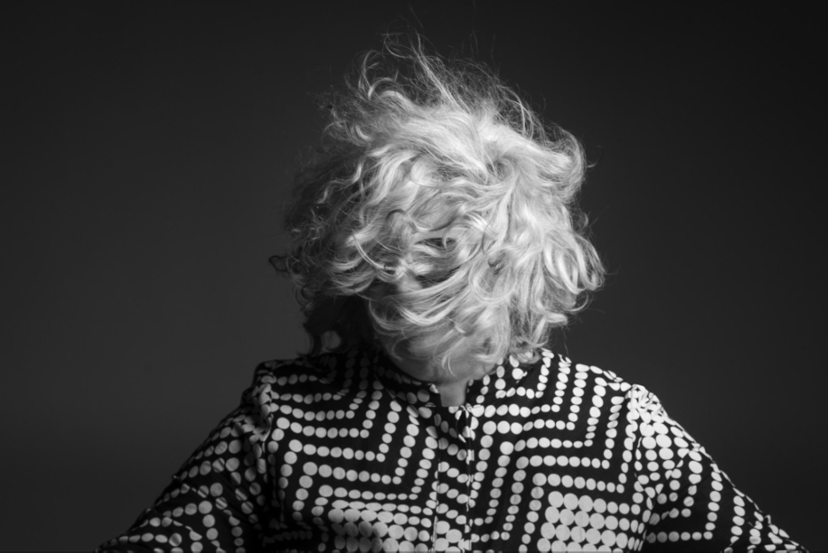 black and white photo of a person with their hair covering their face