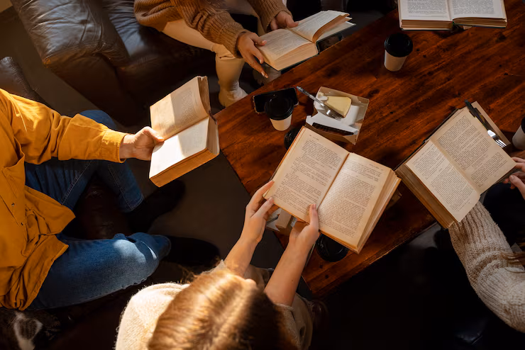 form a high angle, books are seen being held by people in a circle