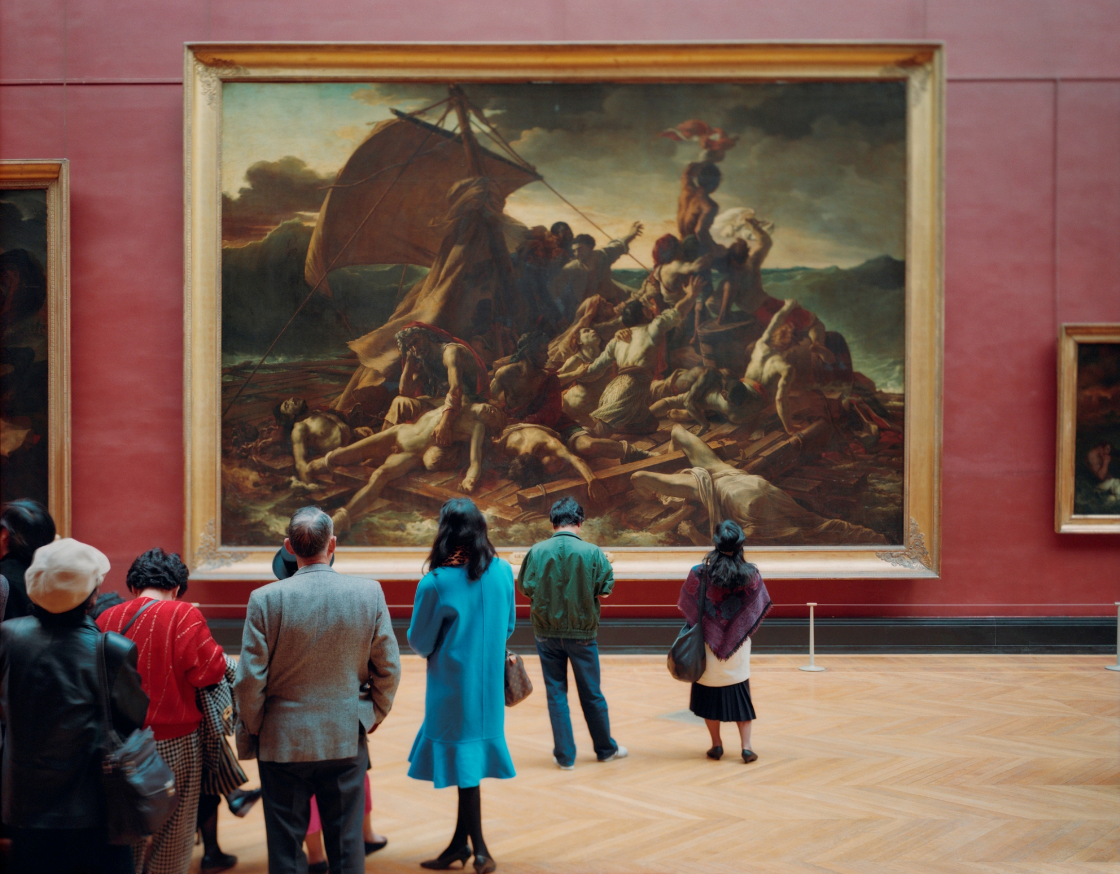 a crowd surrounding the Louvre 