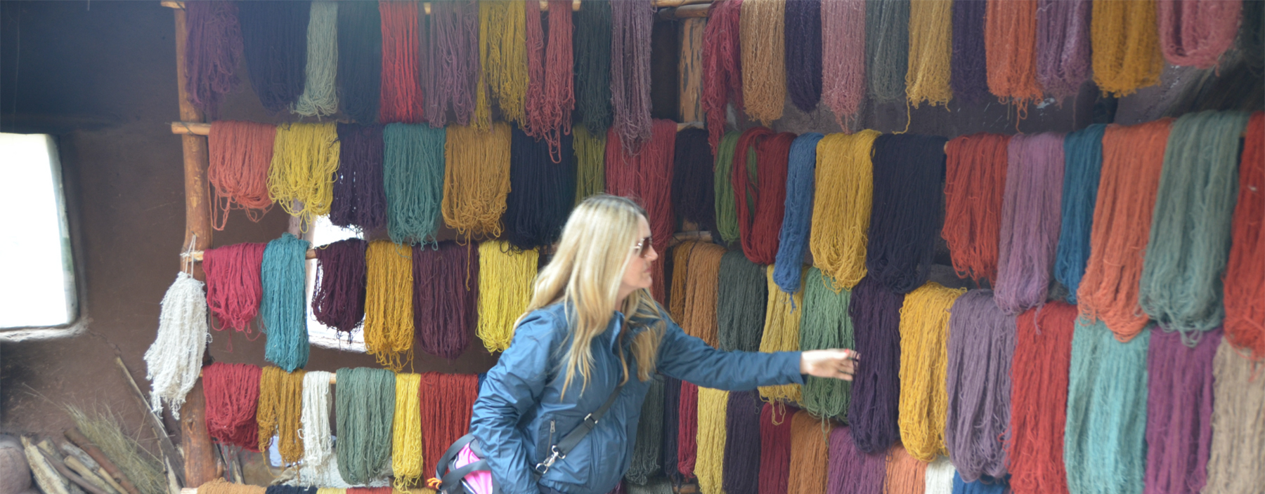 Wall of hand dyed yarn in a market