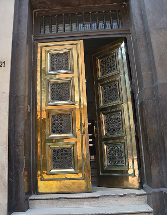 Tall gilded doors set in carved stone