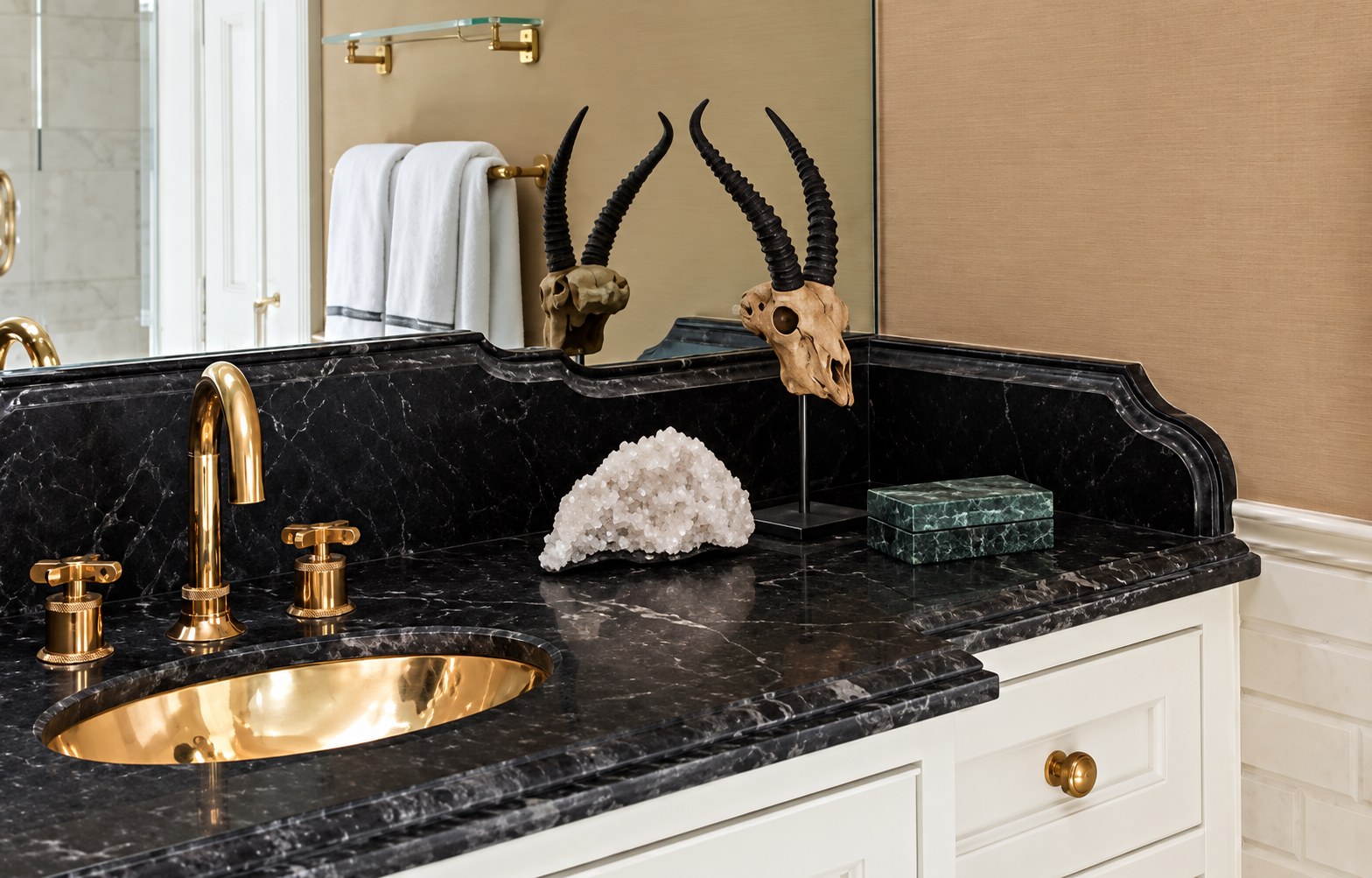 Black marble vanity with brass fixtures