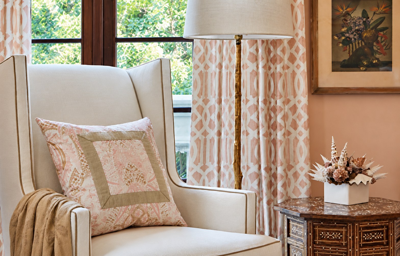 Wing chair beside a curtained window