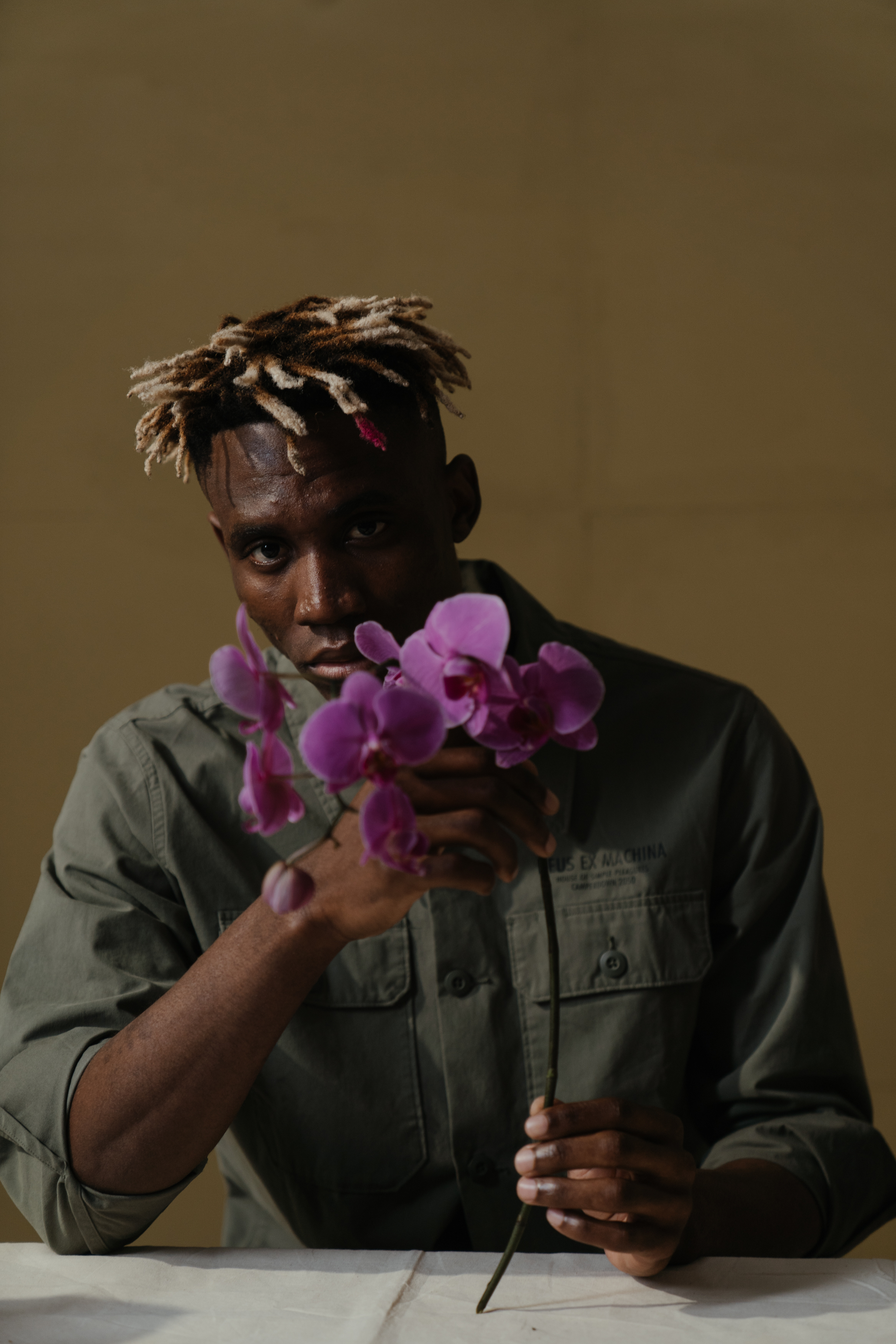 Man with an orchid plant for a home office