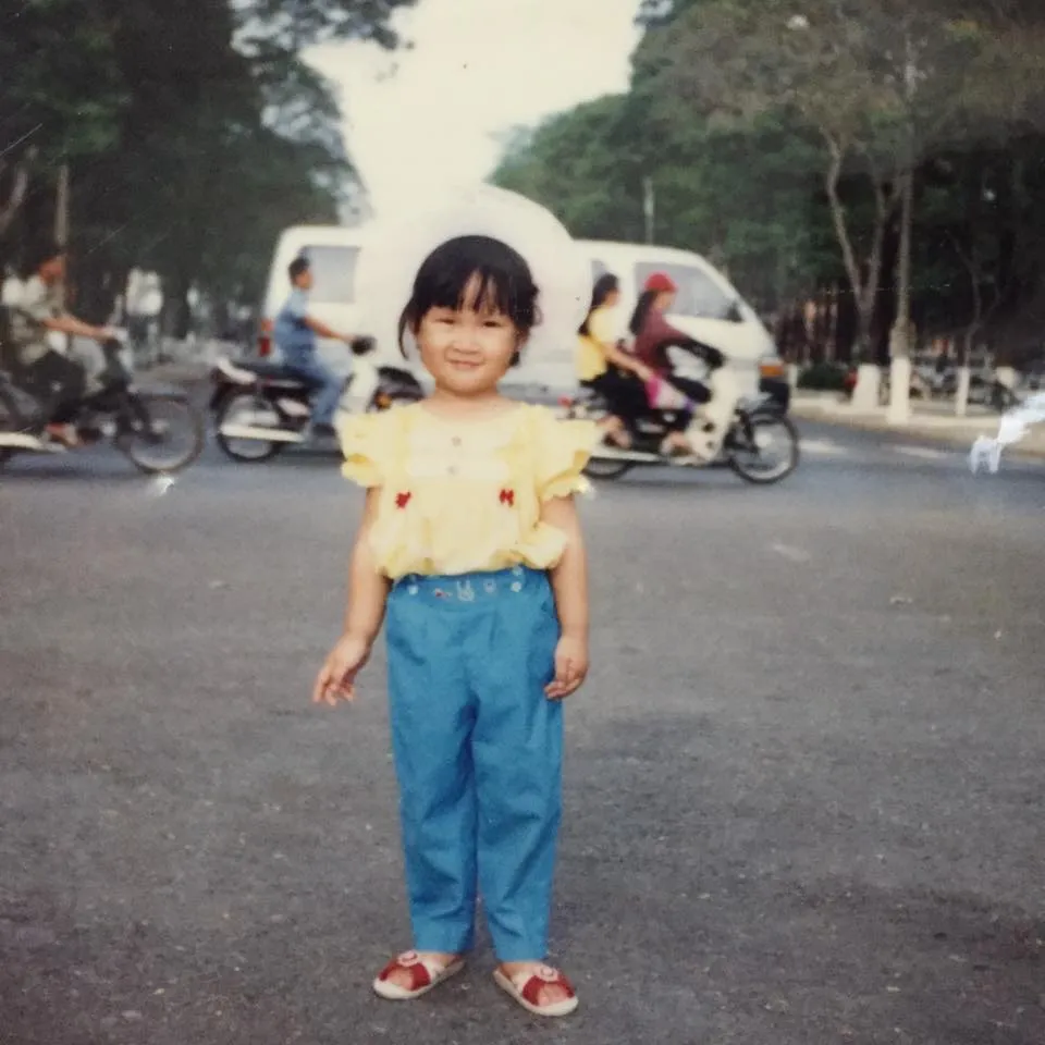 Baby photo in yellow shirt and blue pants