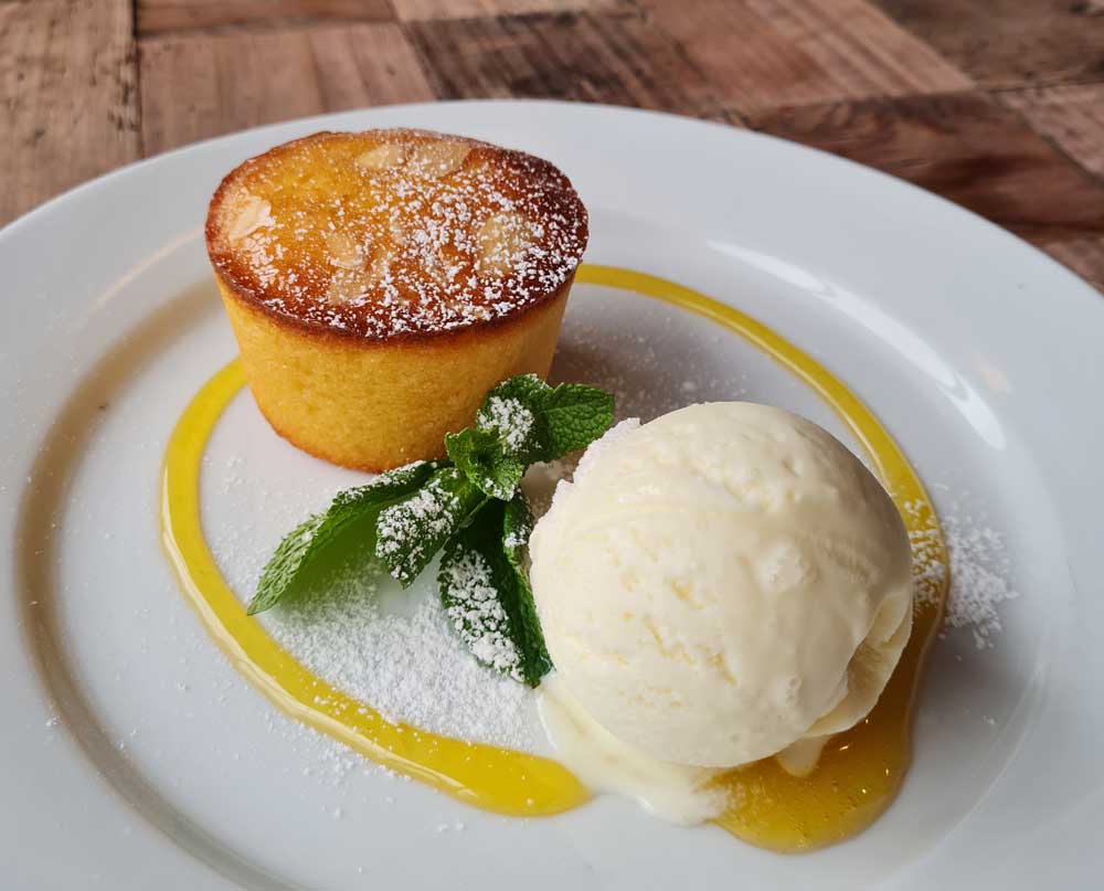 Lemon, Almond, Polenta Cake served with vanilla ice cream
