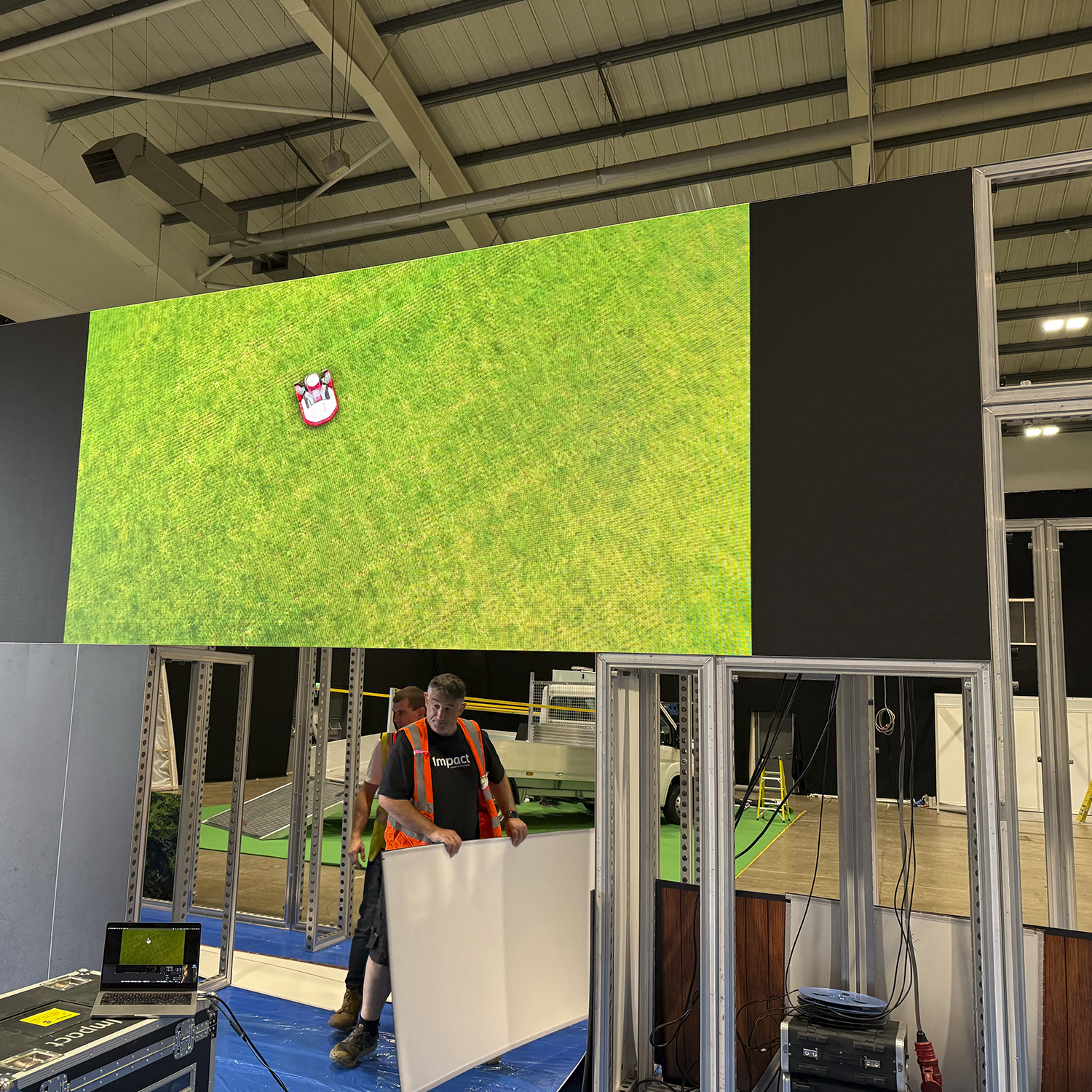 The large LED video wall created including a 3d rendered animorphic view of a Kress RTK mower, built and installed on the indoor Kress stand at Groundsfest 2025