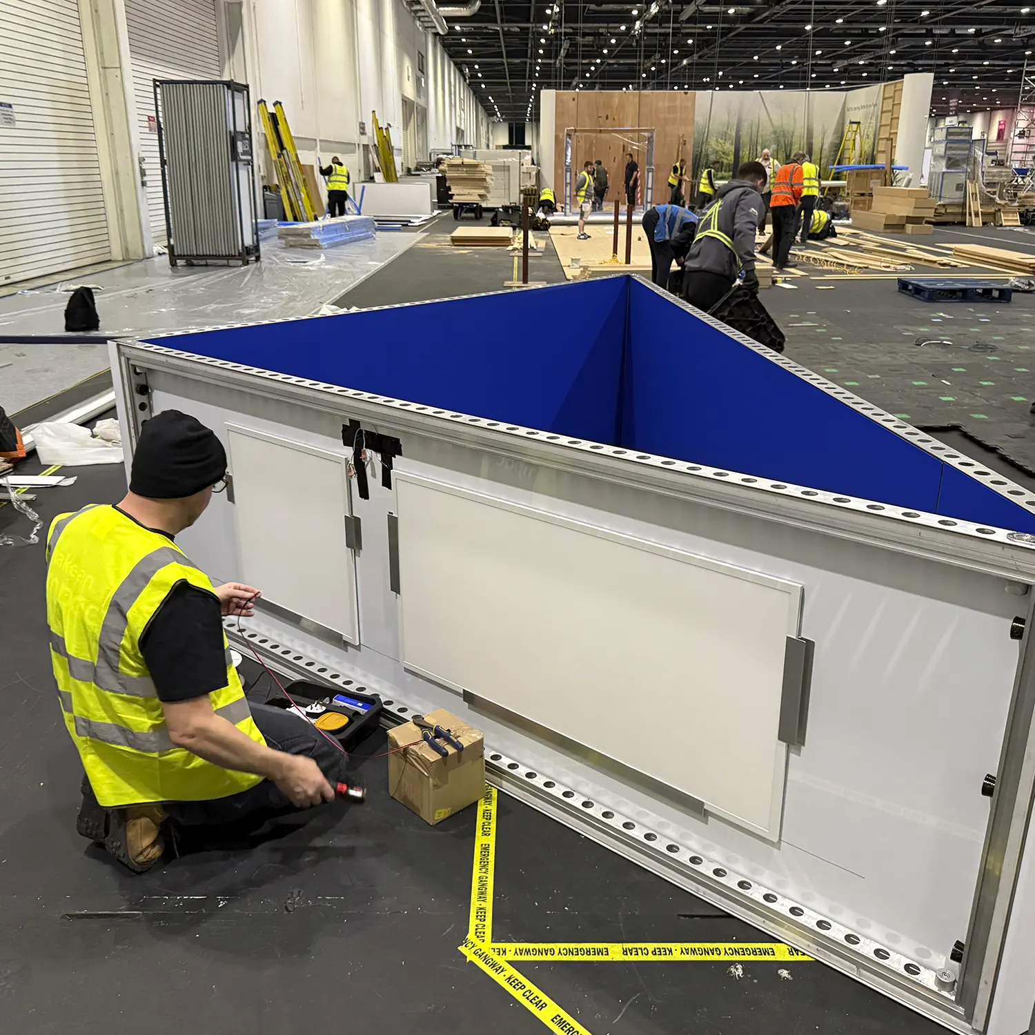 Custom-built exhibition counter with integrated lighting and cable management for HP stand