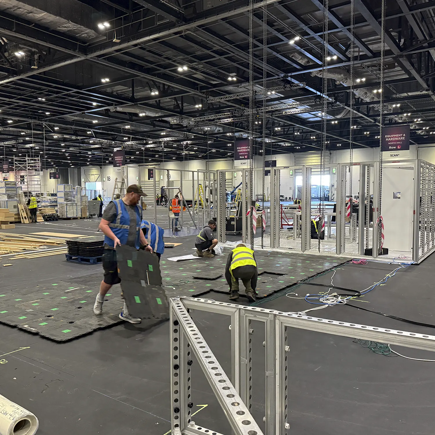 Exhibition graphics being prepared for installation by Impact Design & Print on HP stand at BETT 2026