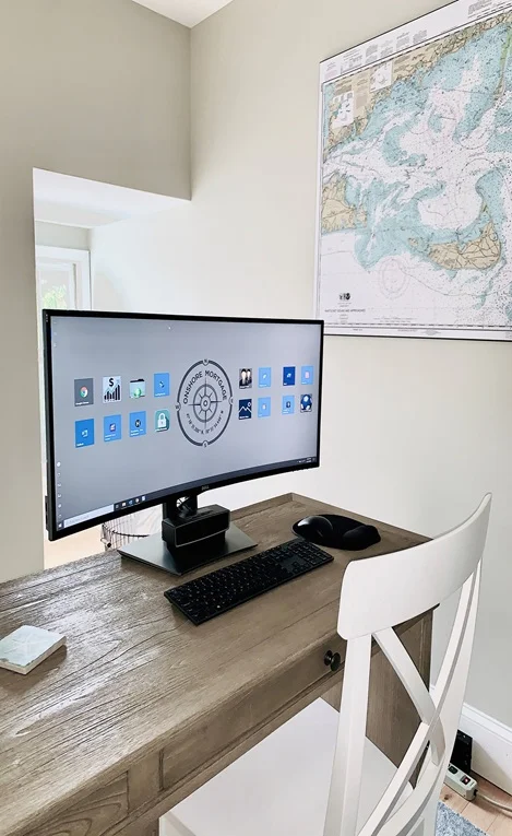 Onshore Mortgage office desk with computer and chair.