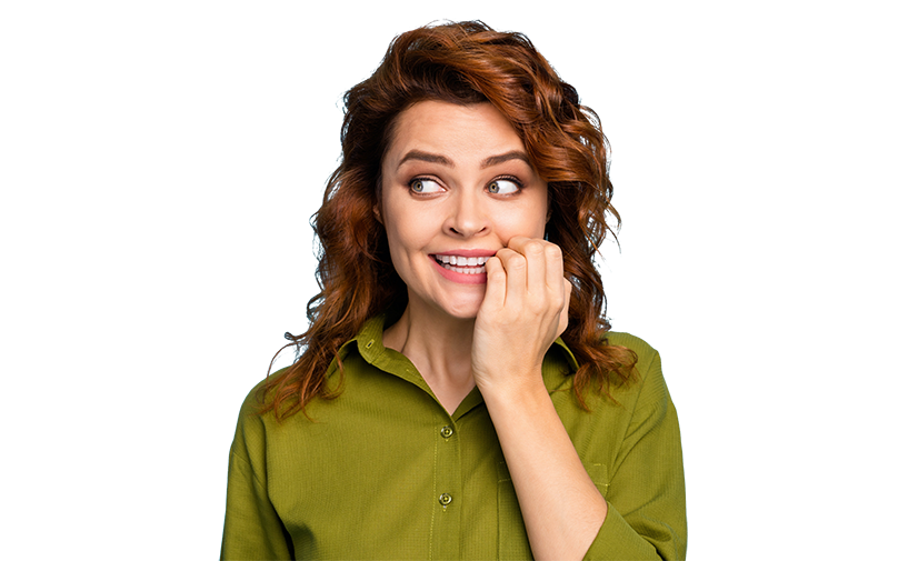 Photo of a woman looking to the side with an expression of anticipation. She has large brown hair and is wearing an apple green sheet. Her left hand , with fingers curled, is held up to her mouth, which has a slight smile.