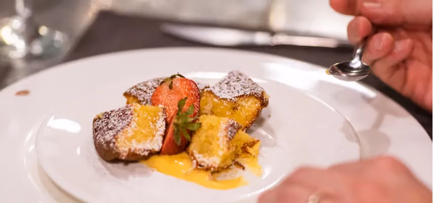 Degustazione di un dessert con crema e fragole