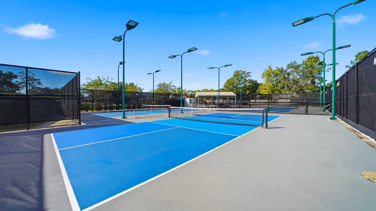 Multiple pickleball courts with blue and green playing surfaces